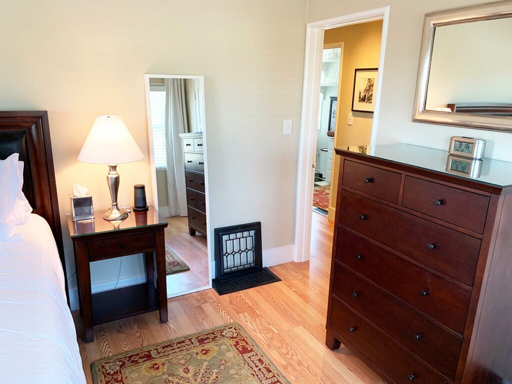 bedside table and four drawer dresser in bed and breakfast bed room.