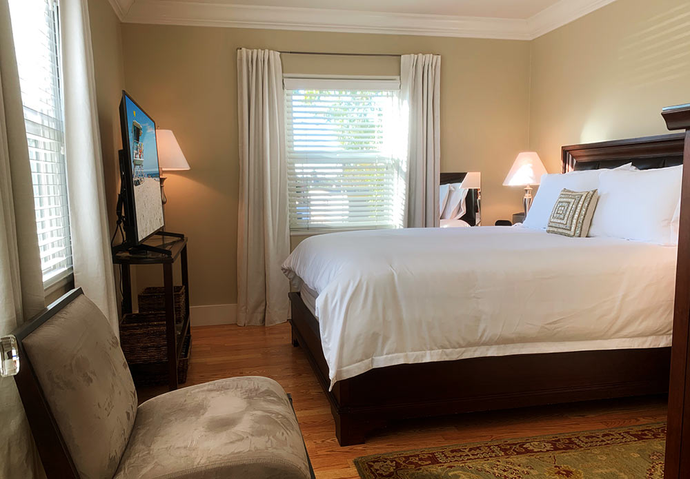 Bed and breakfast guest room with luxurious linens and 45" TV.